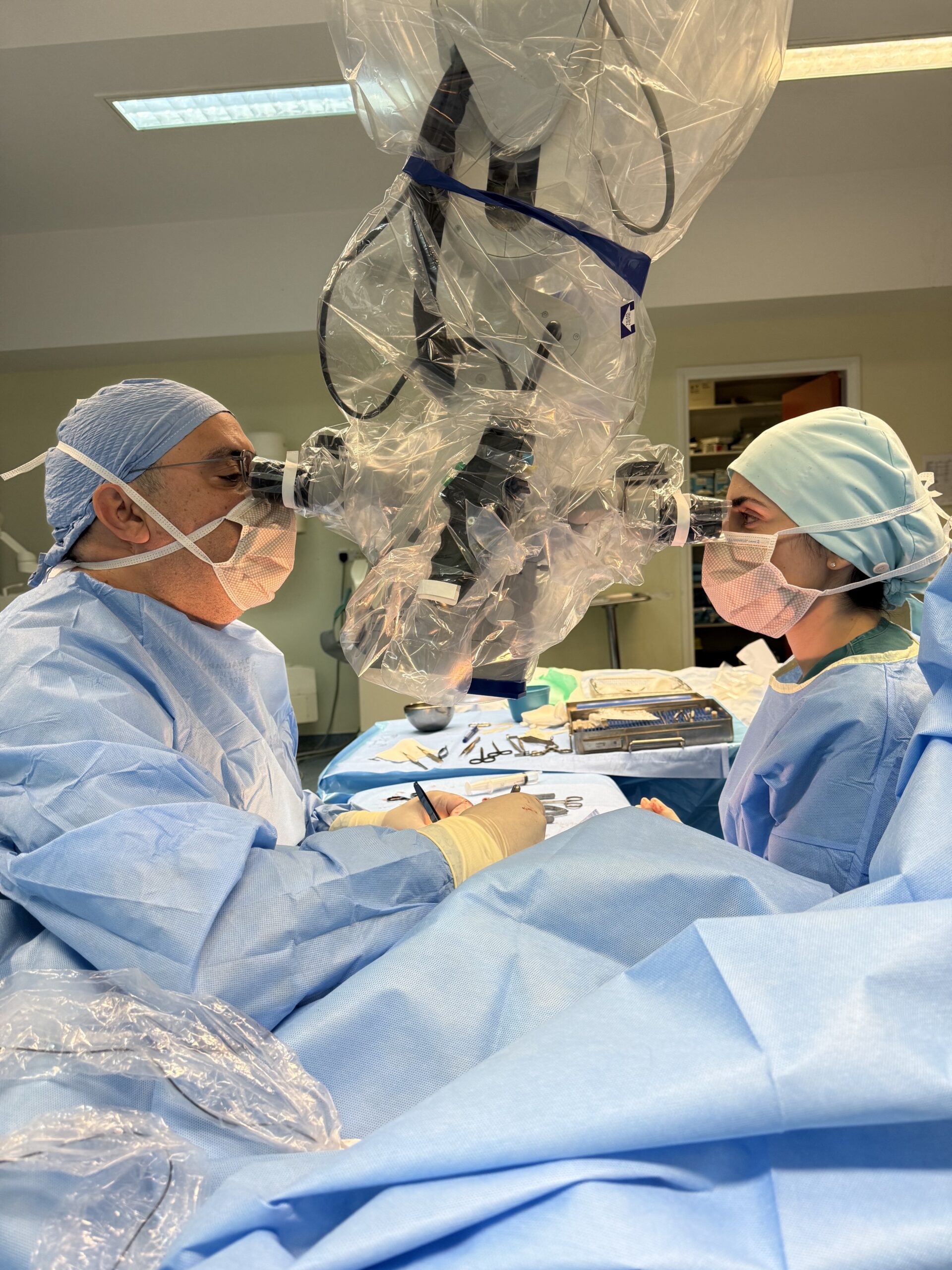 Dr Constantinos Kritiotis performing microsurgery using an operating microscope